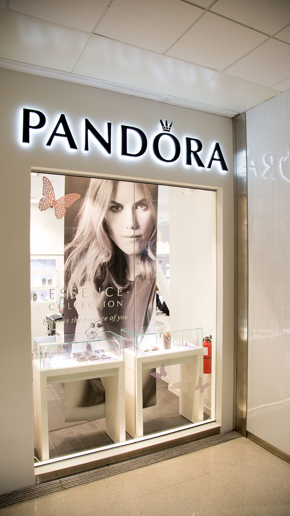 External view of Pandora shop window with the name in large backlit letters over the window.